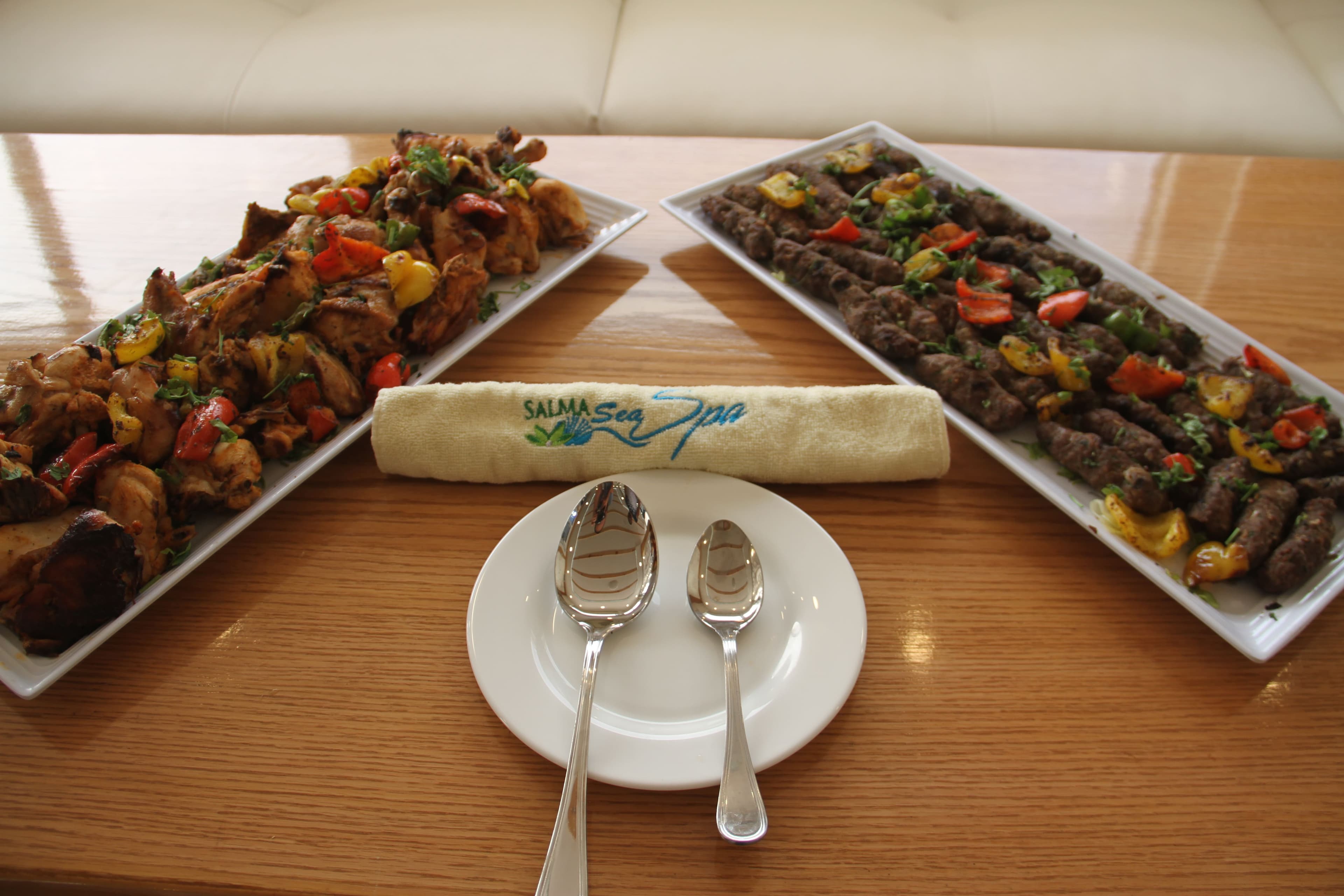 Platters of grilled chicken and kofta served on the saloon table